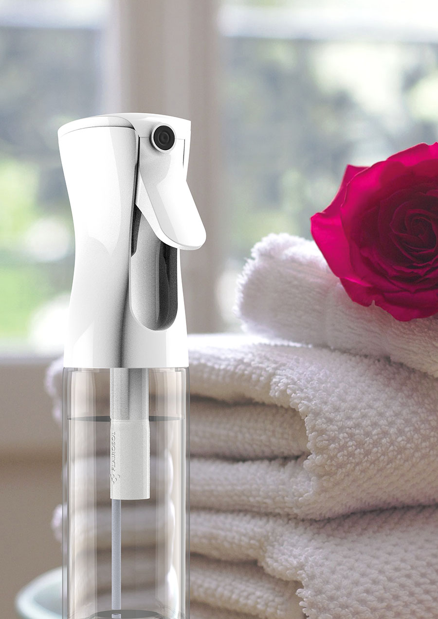 A Flairosol spray pump in front of a stack of towels